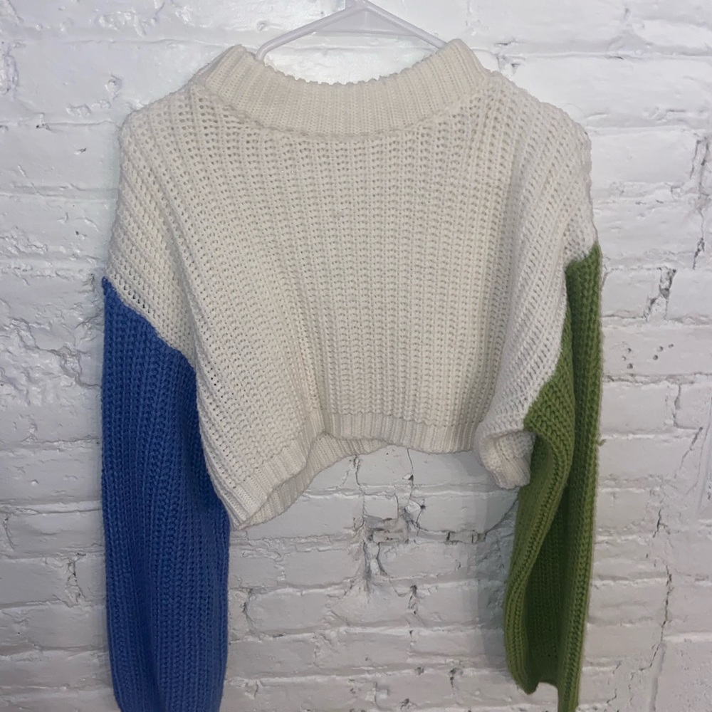 White sweater with multicolor green and blue sleeves